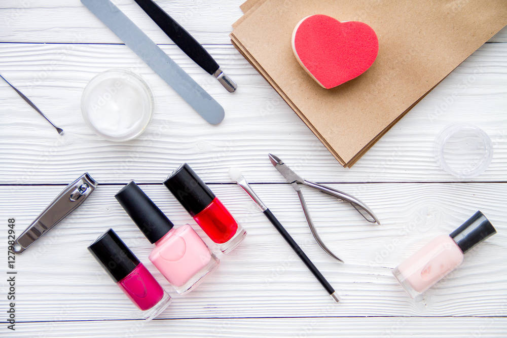 manicure set and nail polish on wooden background manicure set and nail polish on wooden background