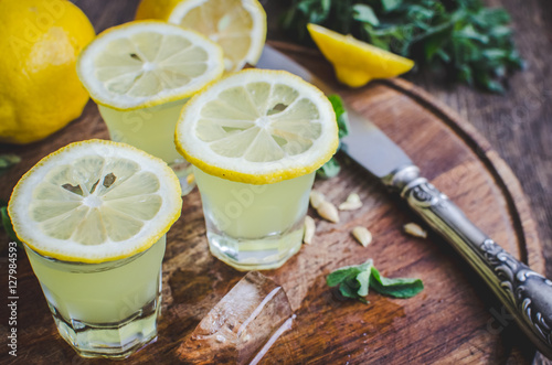 Italian traditional liqueur limoncello with lemon