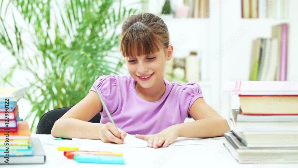 Smiling Girl Doing Her Homework
Smiling Girl Doing Her Homework
