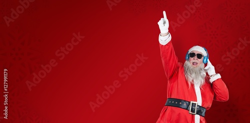 Composite image of santa claus playing dj with raised hand