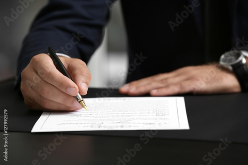 Man signing marriage contra...