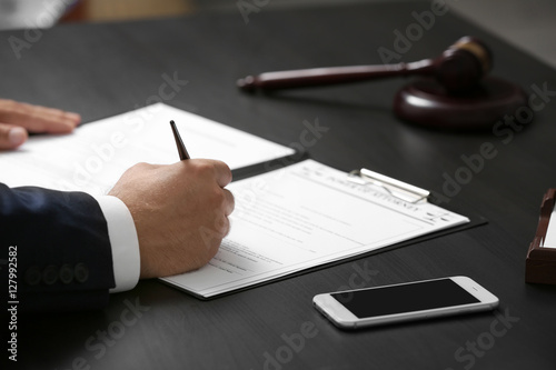 Man signing power of attorn...