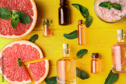Fototapeta Naklejka Na Ścianę i Meble -  Aroma oil with citrus on yellow background