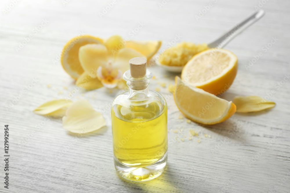 Beautiful spa composition with lemon essential oil on white wooden background, closeup Beautiful spa composition with lemon essential oil on white wooden background, closeup