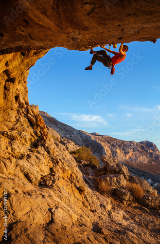 Male climber on overhanging cliff
