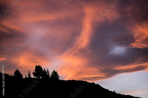 Ridgeline silhouetted against fiery sky