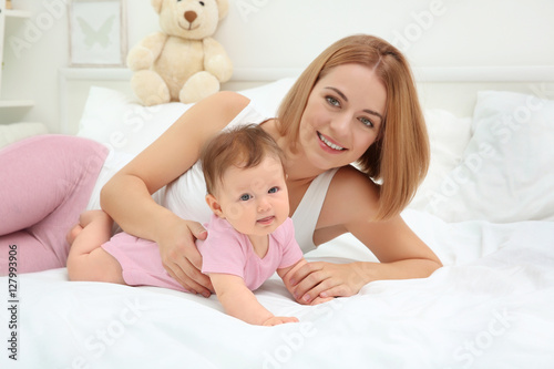 Young mother and baby lying...