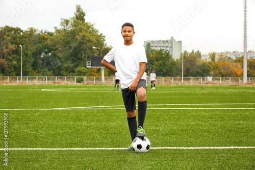 Boy playing football at stadium