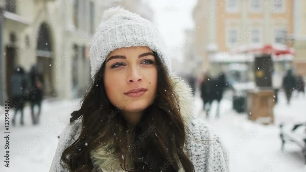 Attractive beautiful lady walking over snowy city background Attractive beautiful lady walking over snowy city background