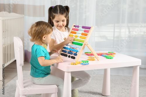 Cute girl playing with litt...