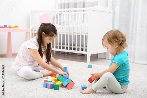 Cute girl playing with litt...
