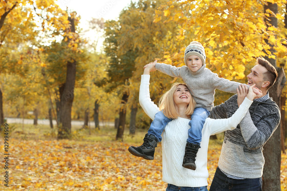 Fototapeta premium Happy family playing in beautiful autumn park