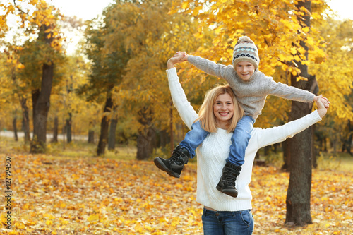 Mother and son playing in beautiful autumn park