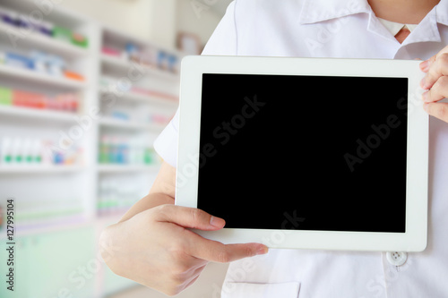 pharmacist showing promotion displaying the blank screen of tabl