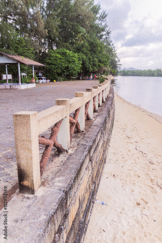 Beachside concrete retaining wall when low tide, Thailand Beachside concrete retaining wall when low tide, Thailand