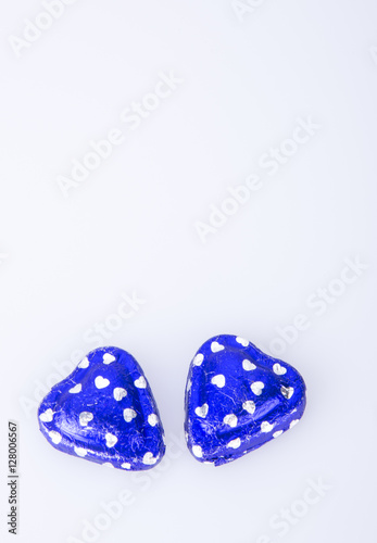 Chocolate or blue heart shape chocolate on a background.