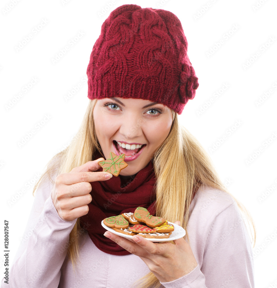 Smiling woman in woolen cap and shawl holding gingerbreads, christmas time Smiling woman in woolen cap and shawl holding gingerbreads, christmas time