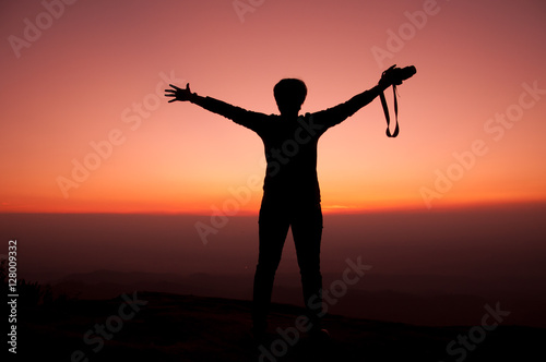 Girl opens arm with sunset sky background, inspiration and freedom concept