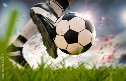 soccer player kicking soccer ball in motion © phonlamaiphoto