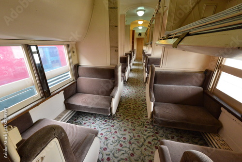 The seats inside of a vintage American railway carriage. 