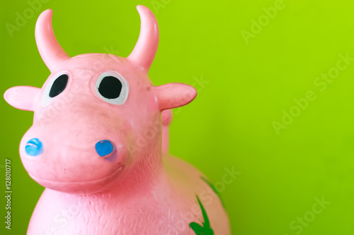 Rubber cow isolated on green background