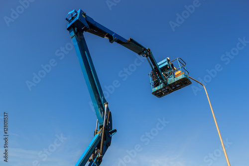 Wallpaper Mural Electric technical repairing street light by boom lift in industrial  Torontodigital.ca