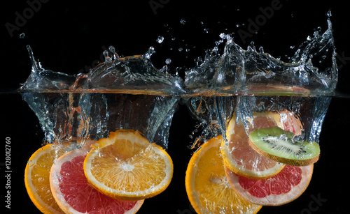 Orange  lemon  grapefruit and lime splashing into water