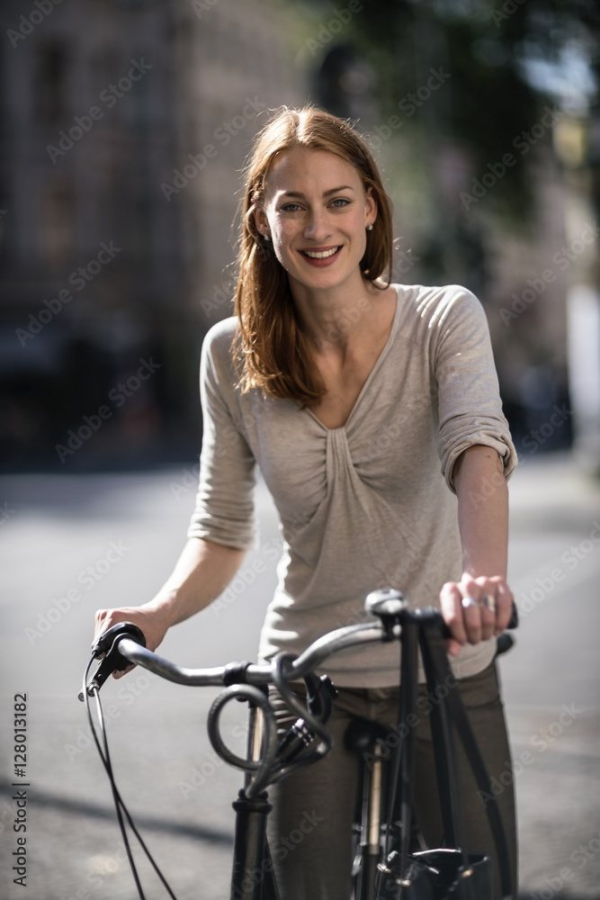 Portrait of redheaded woman with bicycle Portrait of redheaded woman with bicycle