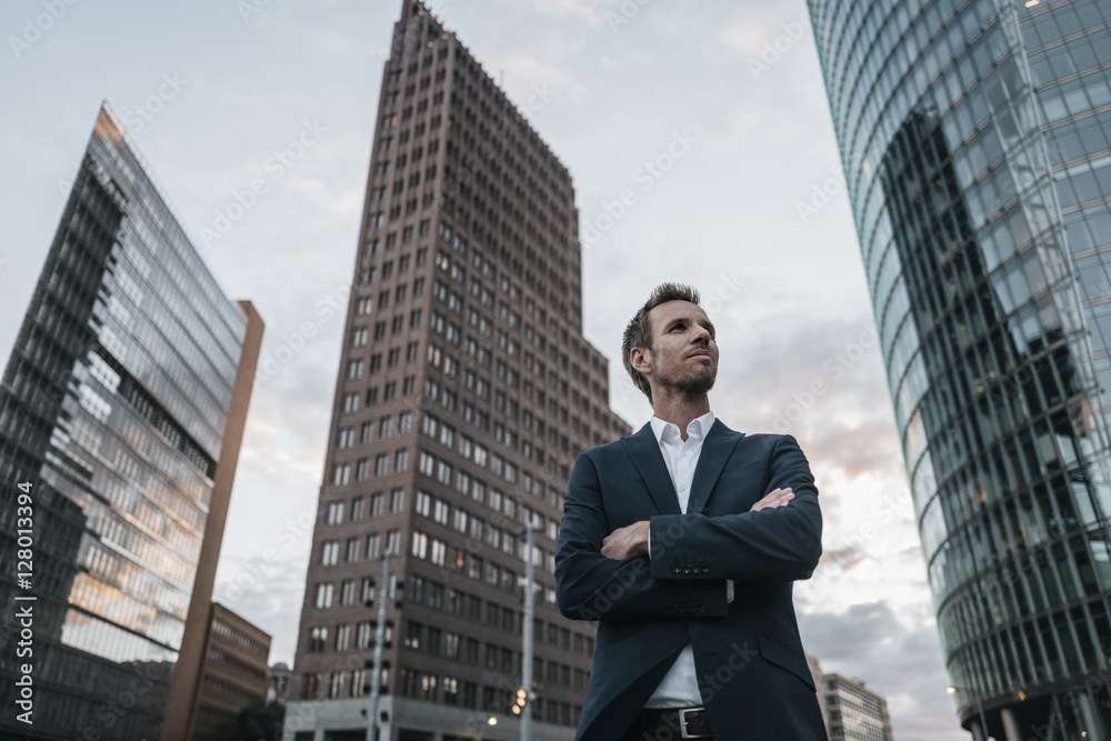 Germany, Berlin, businessman with arms crossed standing at Potsdamer Platz Germany, Berlin, businessman with arms crossed standing at Potsdamer Platz