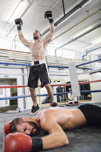Boxer celebrating victory over his opponent