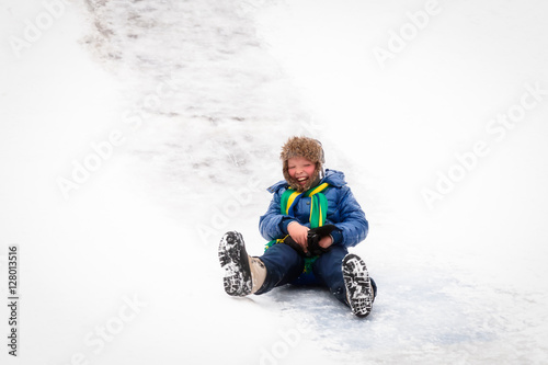 Wallpaper Mural Boy riding the ice slides in the winter Torontodigital.ca