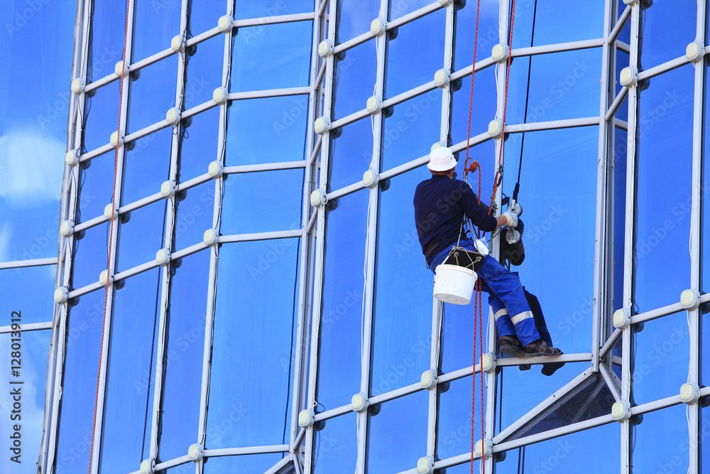 window cleaner on the facade of the building