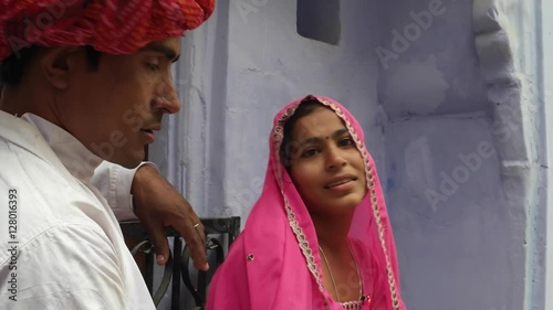 Man asking for forgivness for being late to his beautiful woman in traditional dress in Rajasthan India  photo