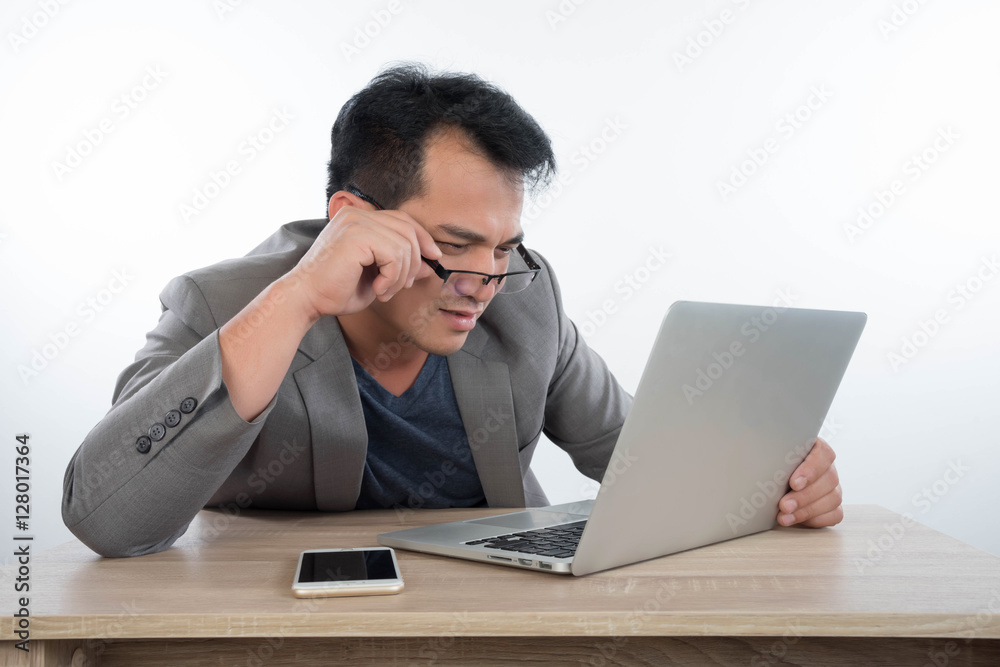 young businessman Stressful jobs using a laptop sitting thinking young businessman Stressful jobs using a laptop sitting thinking
