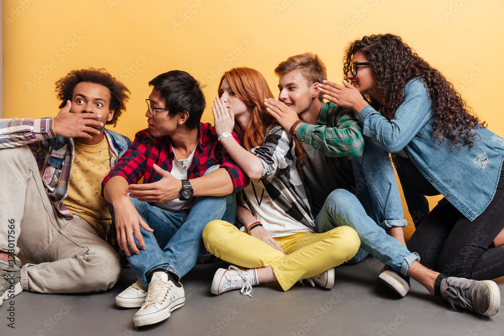 Group of people surprising and telling secrets to each other Group of people surprising and telling secrets to each other