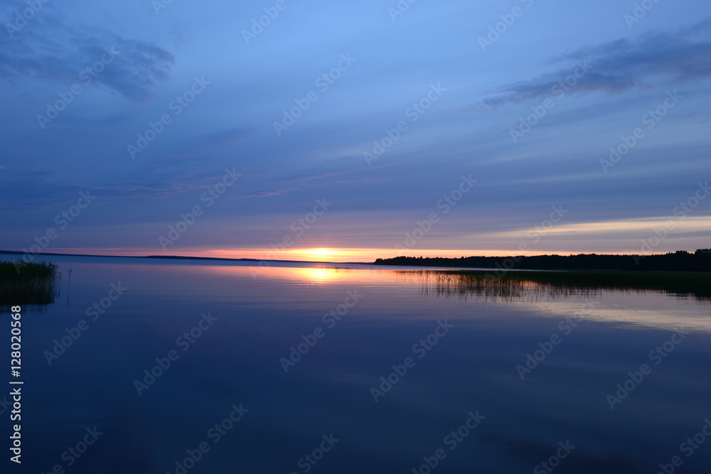 Bright sunset on a blue azure water of the lake