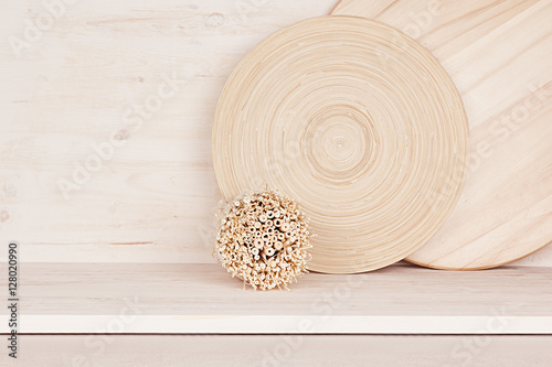 Soft home decor of wooden plate and stems on white wood background. Interior.