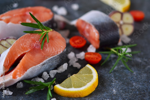 Fresh raw salmon steak with lemon and salt.