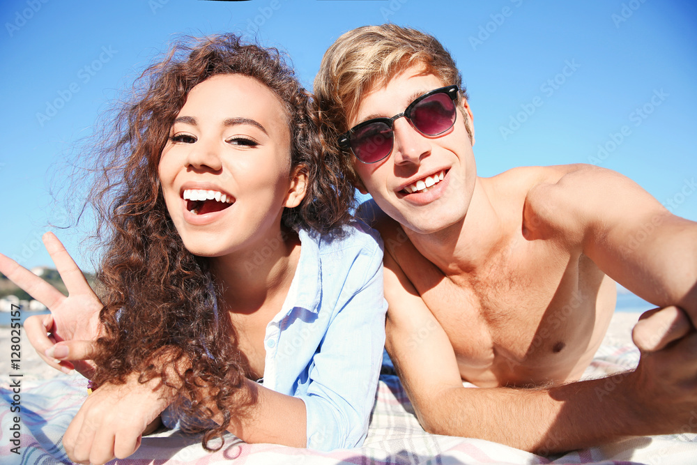 Happy couple taking selfie on beach Happy couple taking selfie on beach