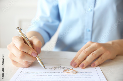 Woman signing marriage cont...