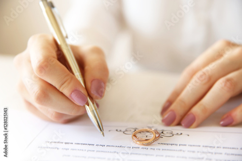 Woman signing marriage cont...