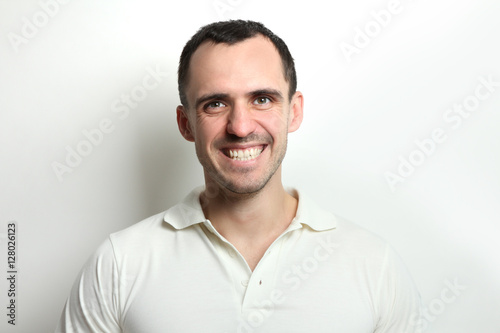 Portrait of a happy young man on a light background. © Studio KIVI