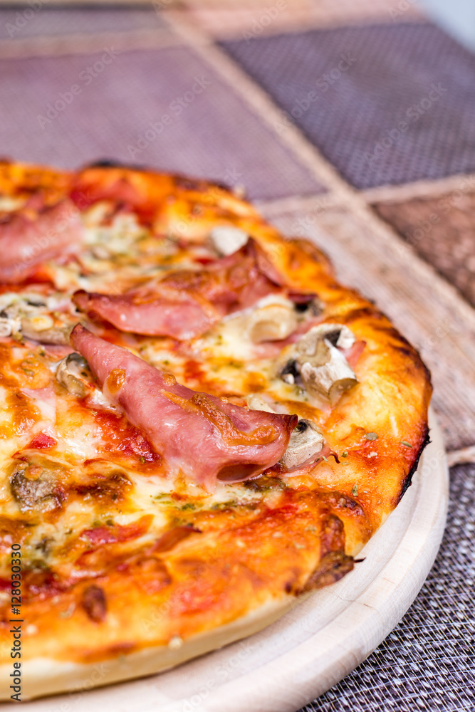 Closeup macro view pizza with ham cheese mushrooms
