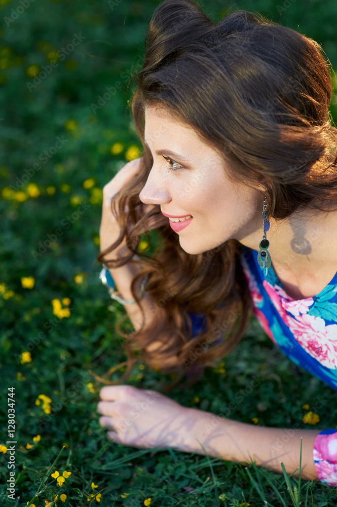 happy young woman lying on green grass happy young woman lying on green grass