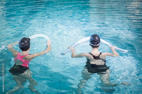 Women in the pool with foam rollers photo