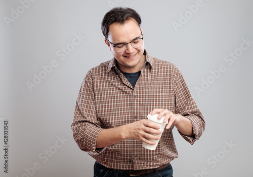 Portrait of a man opening and smelling coffee