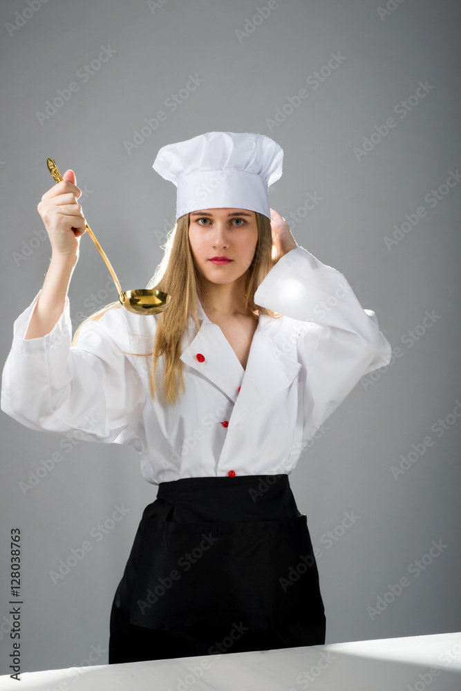Cooking, eating, study. Girl with a ladle in cooking hat.