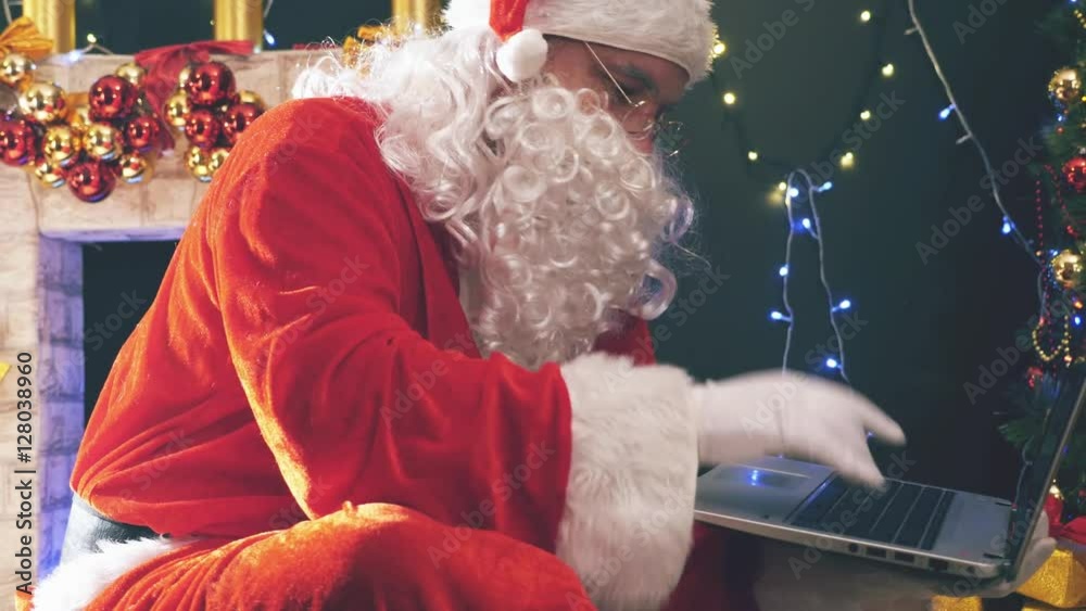 Santa buying gifts use laptop computer