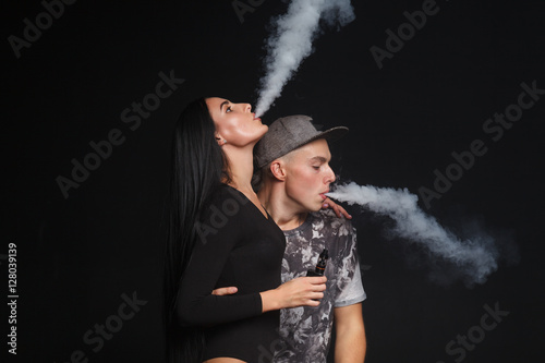 a man and woman smoking electronic cigarette