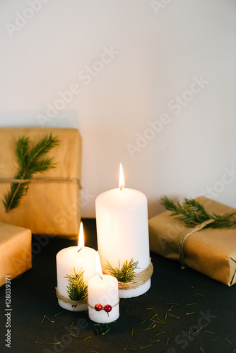 Christmas decorations with lit candles and gift boxes